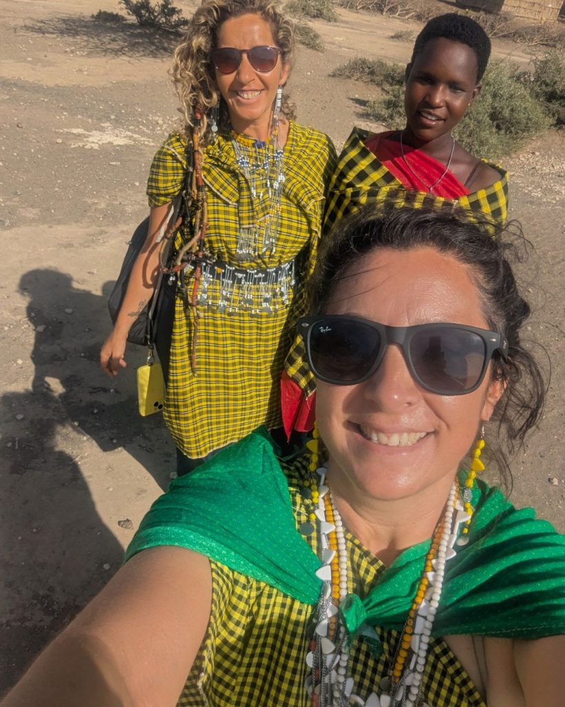 Volunteers participating in cultural exchange with Maasai women in Tanzania, authentic cultural immersion, community living and volunteer experience in Africa.
