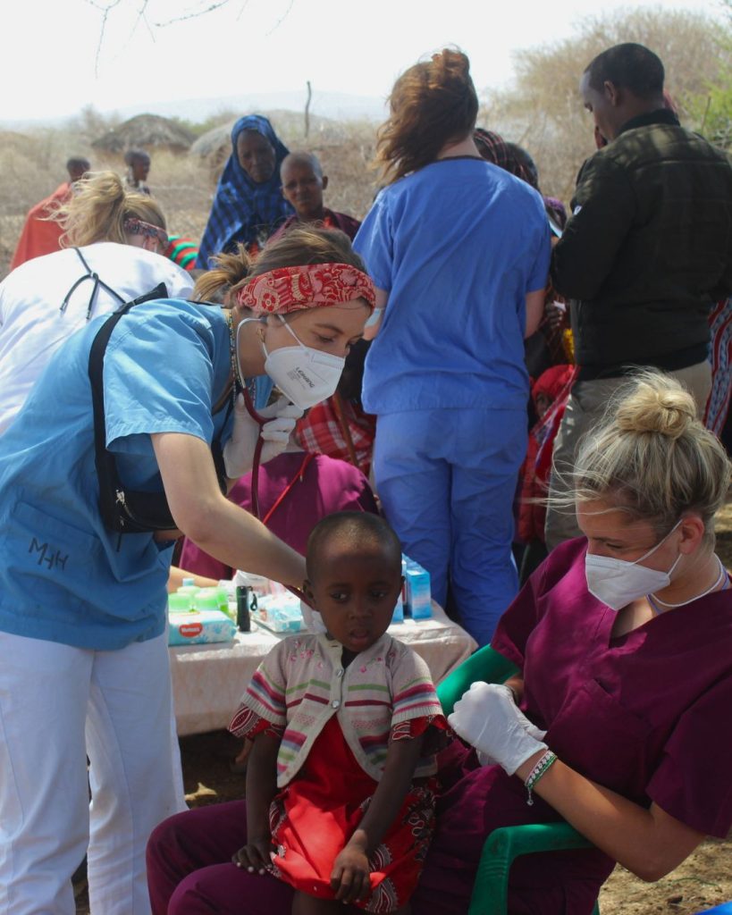 Health volunteers providing community medical care for Maasai children in Tanzania, rural healthcare outreach program, medical volunteering and support for local communities in Africa.