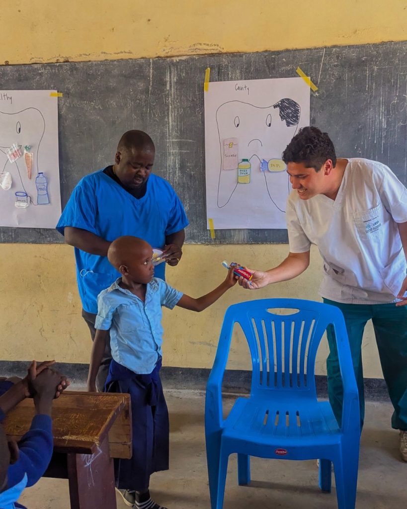 Volunteer supporting education activities with local staff in a Maasai community school in Tanzania, teaching assistance, child development and community volunteer program in Africa.